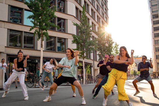 Flashmob dance event organized by the studio in a public square.